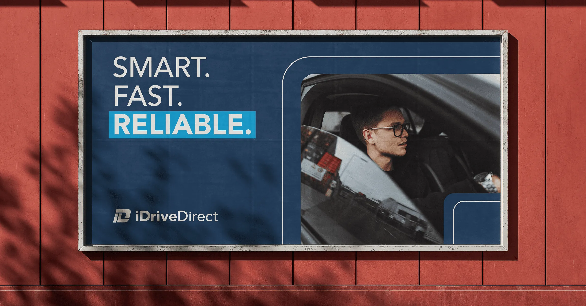 iDriveDirect billboard reading “Smart. Fast. Reliable.” on a red wall