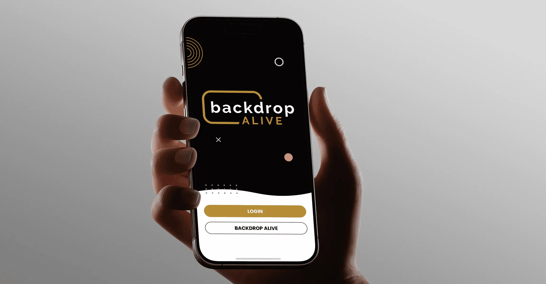 Hand holding a phone showing the Backdrop Alive login screen