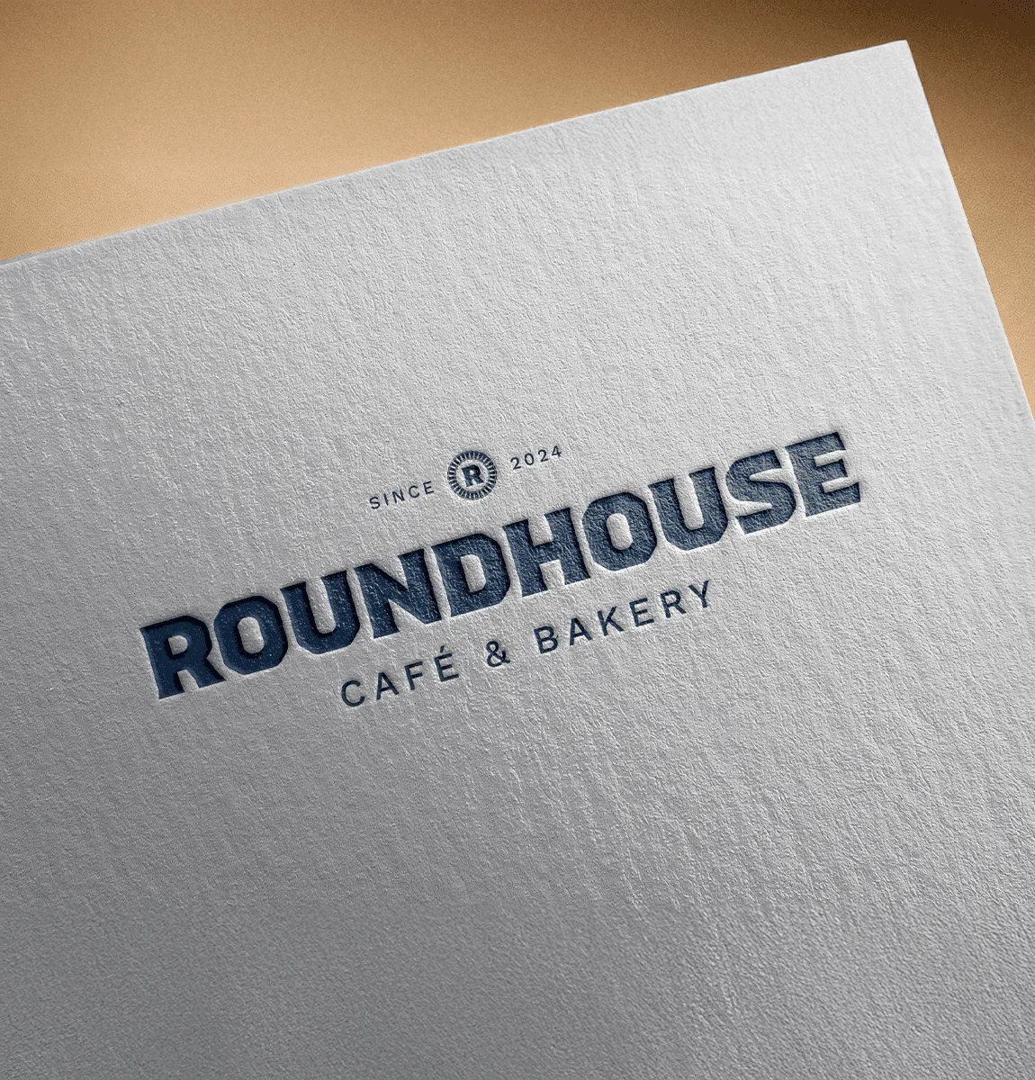 Roundhouse Café & Bakery logo embossed on textured paper